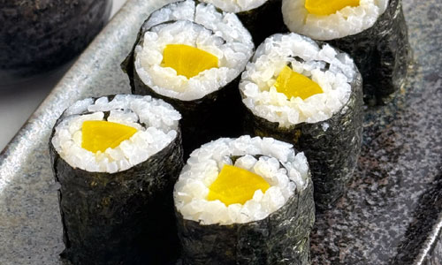Oshinko Roll sliced on a board